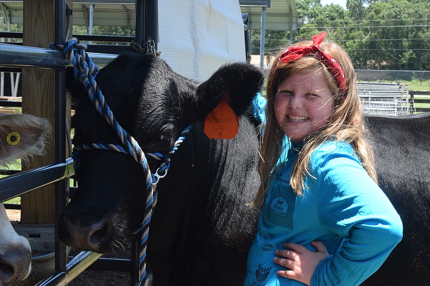 Mary Anne Poulton, a rising fourth grader, bonds with Dak.