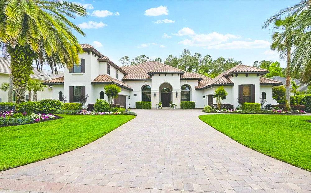 This Spanish style two-story home features four bedrooms, four bathrooms, office, exercise room, game room, summer kitchen and screened pool and spa.