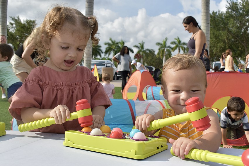 University Park resident Sabine Ladwig and Sarasota resident Caleb Daniels make friends over a game of whack-a-mole.