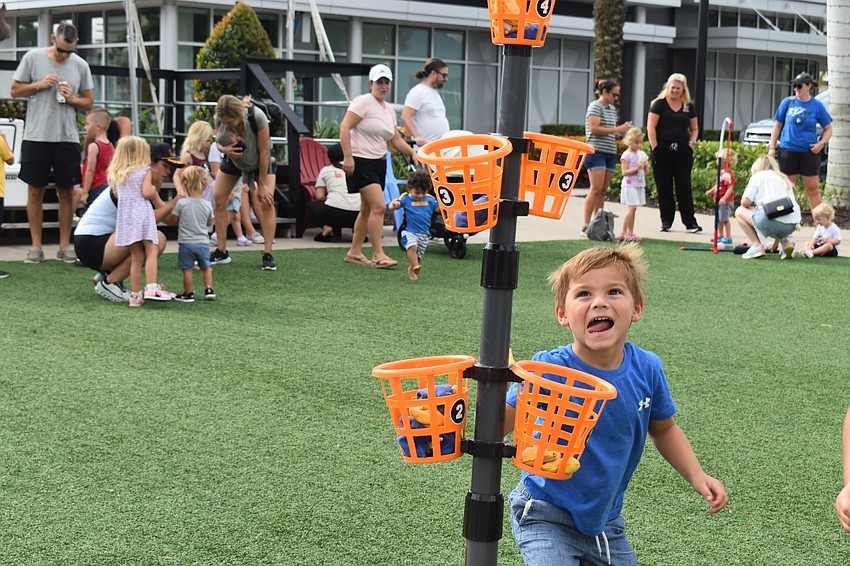 After a lot of tries, Palm Air resident Andrew Mullen gets a bean bag in the top basket.