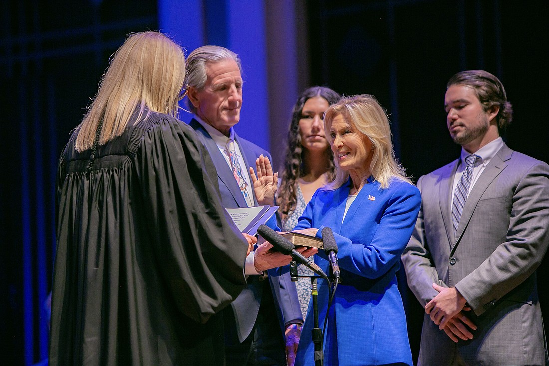 Donna Deegan is sworn in as mayor July 1 at the Jacksonville Center for the Performing Arts by Duval County Judge Kimberly Sadler. Holding the Bible is Deegan's husband, Tim Deegan. Watching are her children, Danielle and Drew Hicken.
