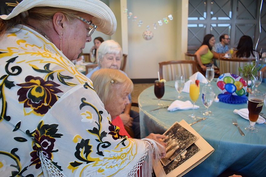 Sherry King looks at her parents' wedding photos with her mother Shirley Martin.