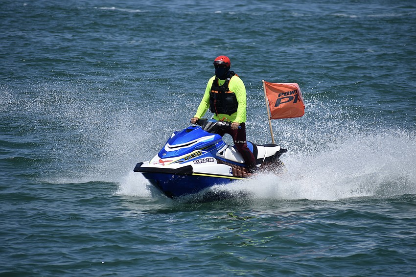 A support jetski comes to the aid of a boat.