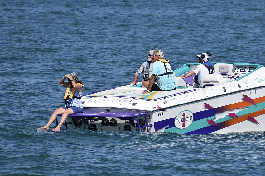 Support boat crew members watch the race.