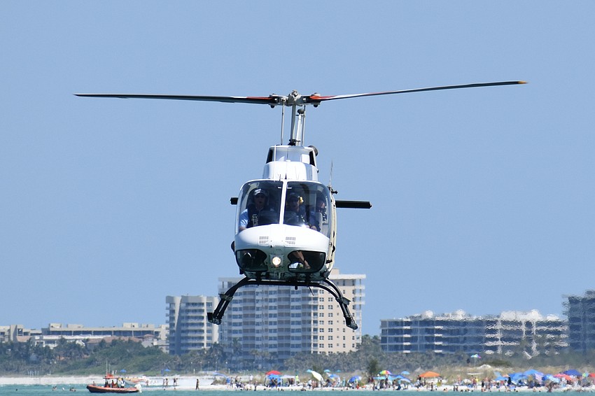 A helicopter crew supervises the race.