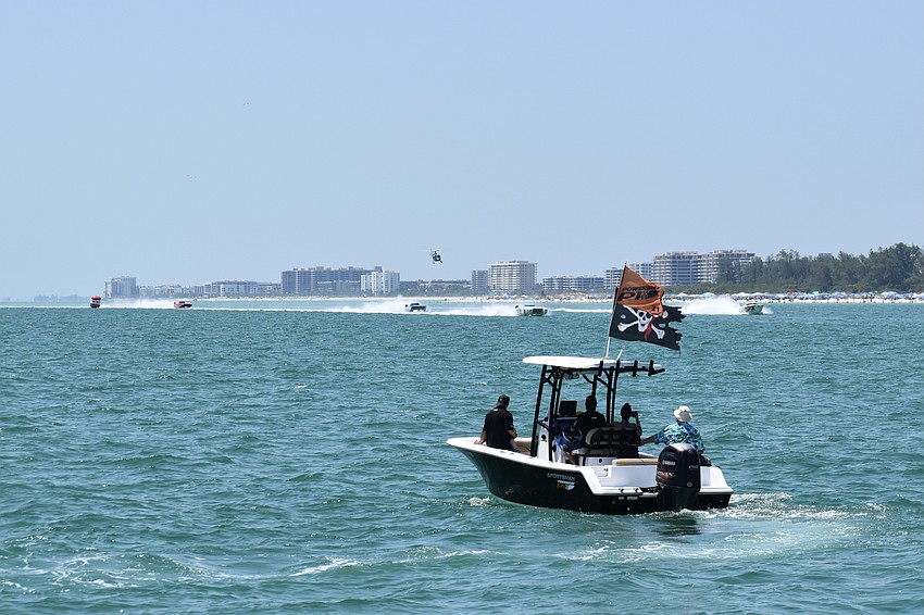 A support boat offers supervision as a race begins.