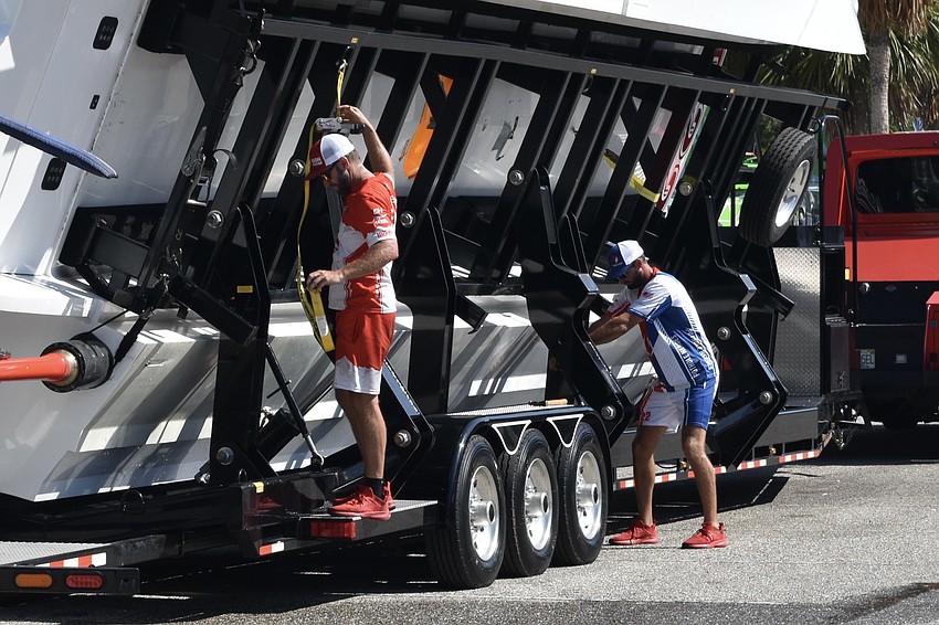 Braden Verkaik of SVEA Racing and Patrick Cleveland of Alegra Motorsports prepare a boat for transportation after the race.