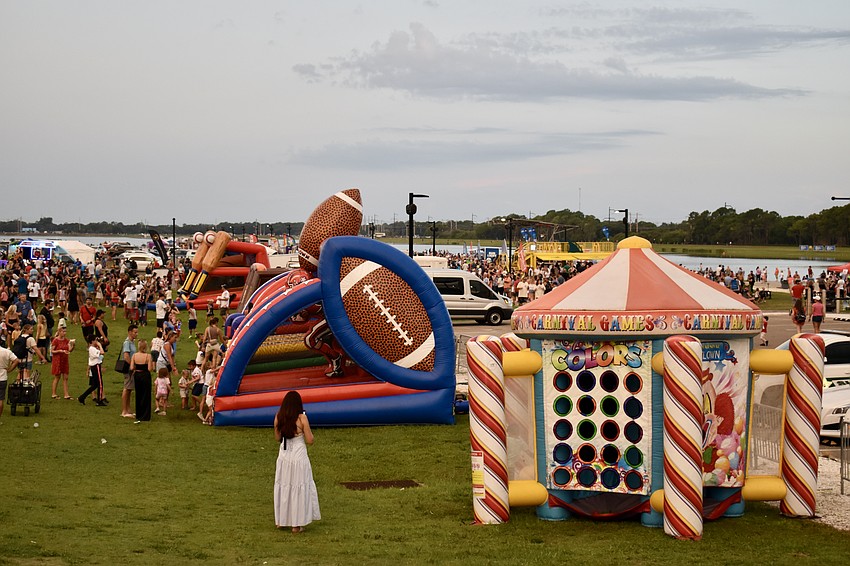 The main area by the finish tower offers bounce houses, food trucks and live music before the fireworks.