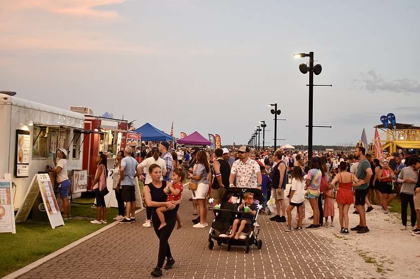 Vendors are lined up serving hot dogs, Chick-fil-A, Kona Ice and more.