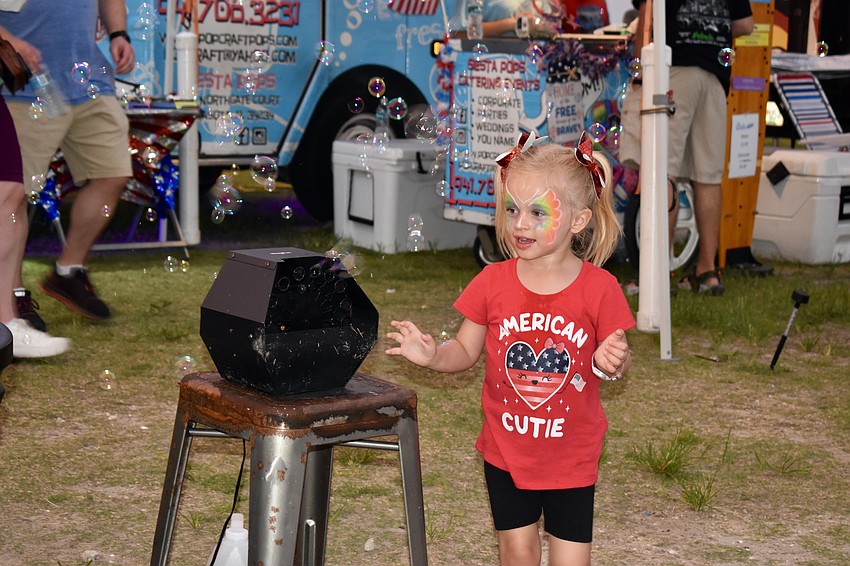 Bradenton resident Juliana Radcliffe enjoys everything the pre-fireworks show has to offer at Nathan Benderson Park.