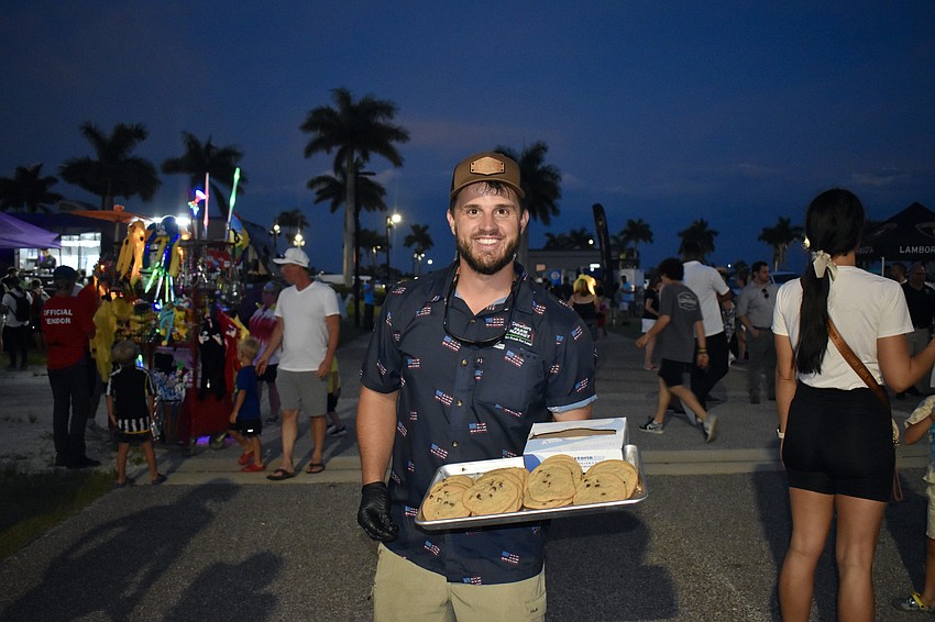 Henry Detwiler passes out free chocolate chip cookies. This is one tray of about 4,000 cookies.