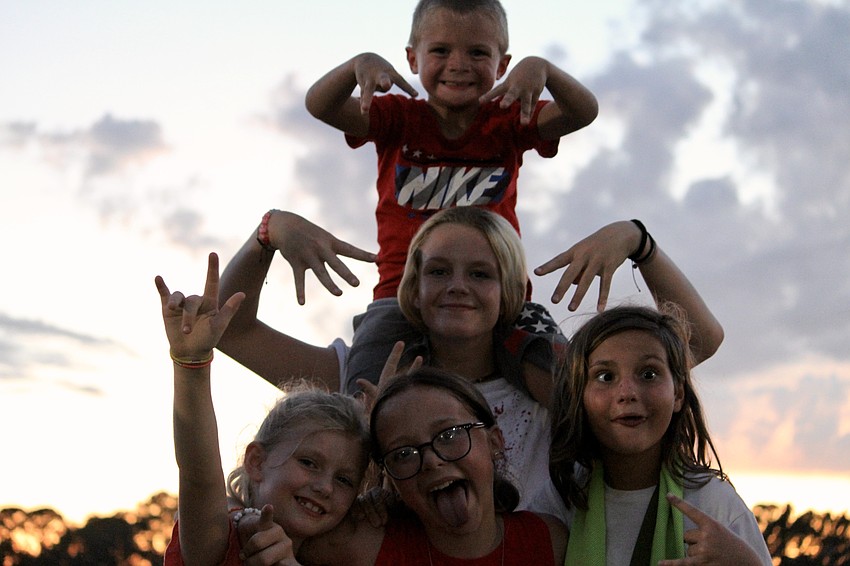 Palmetto resident Braden Olynik takes the top of the pyramid on his sister Aubrey Olynik's shoulders. On the bottom are Bradenton residents Vivianne Posey, Christina Lenneman and Palmetto resident Nevaeh Olynik.