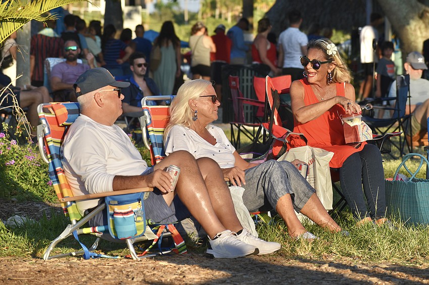 Paul Goevel, Ginny Goevel, and Cari Vinci wait for the fireworks to start.