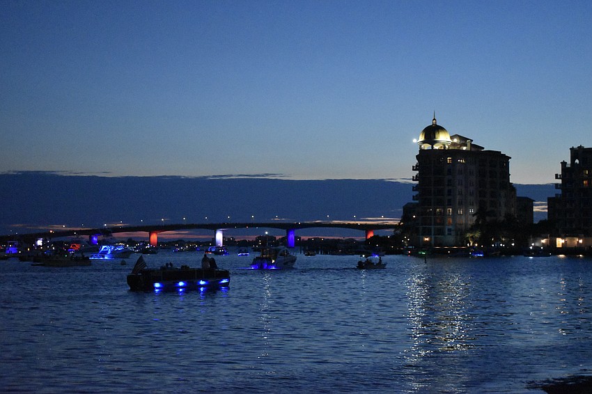 The John Ringling Causeway is lit with Fourth of July colors.