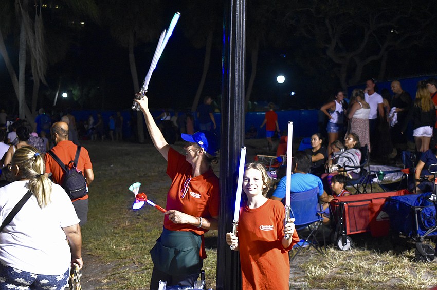 Lauren Duvsky and 11-year-old Christopher Duvsky sold light-up toys at the event.