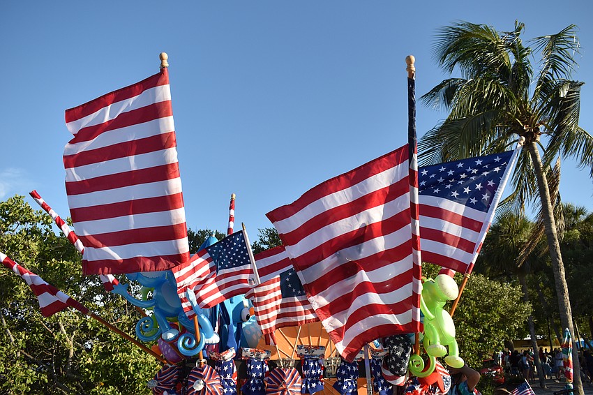 American flags top a merchandise stand in the park.