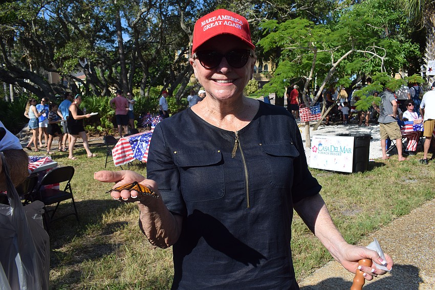Phyllis Black catching a butterfly from the butterfly release.