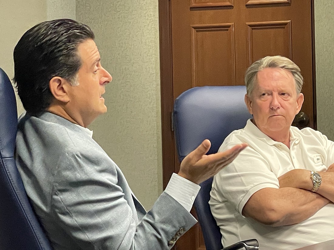 City General Counsel Qualifications Review Committee Chair Jason Gabriel, left, and committee member John Delaney discuss the process of selecting the city's next top attorney during a July 5 meeting at City Hall.
