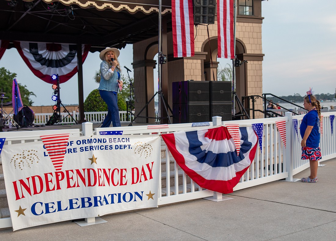 Ava Stewart, 8, watches Traces of Gold entertain the crowd before the fireworks. Photo by Suzanne McCarthy