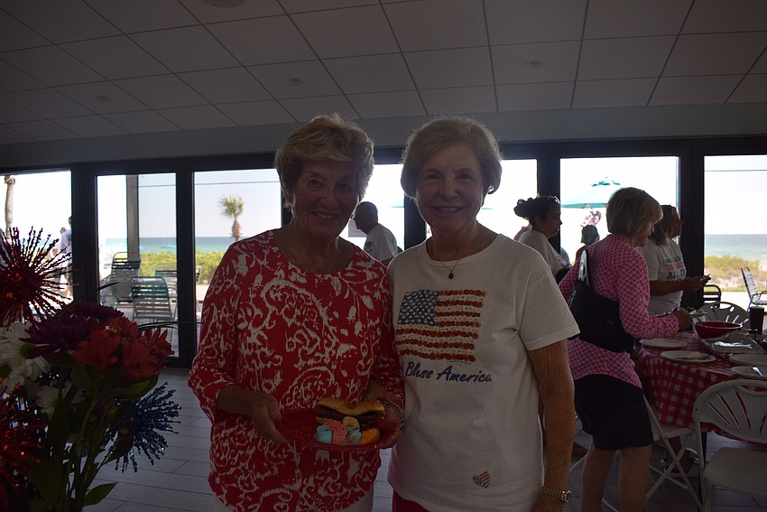 Sue Antonello and Ronda Montminy enjoying the desserts table at the Seaplace Fourth of July party.