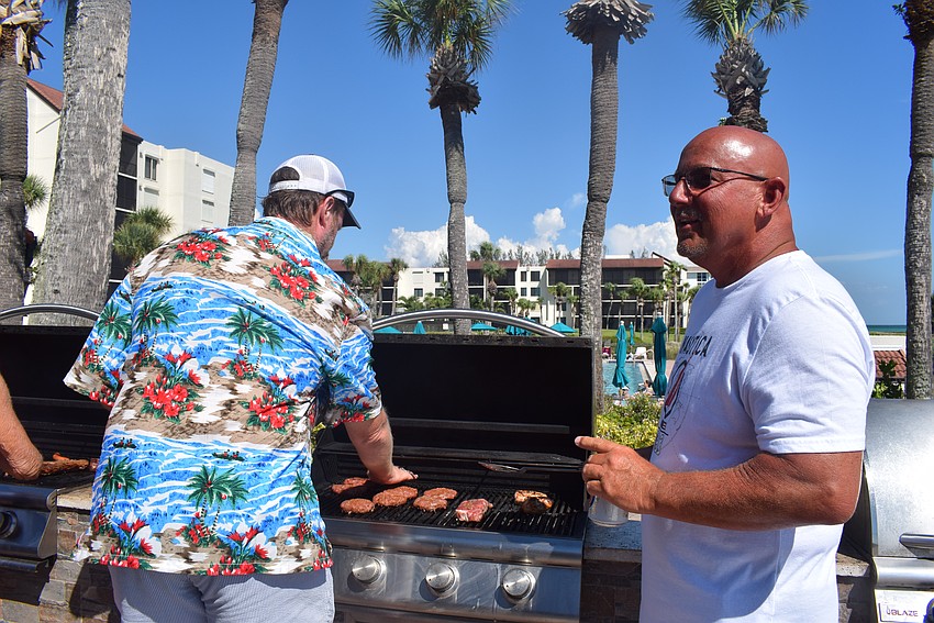 Seaplace residents grilling some hamburgers and hot dogs for their Fourth of July party.