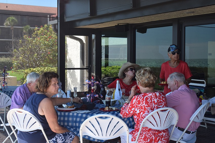 Residents of Seaplace Condo have a nice Fourth of July dinner on their clubhouse patio.