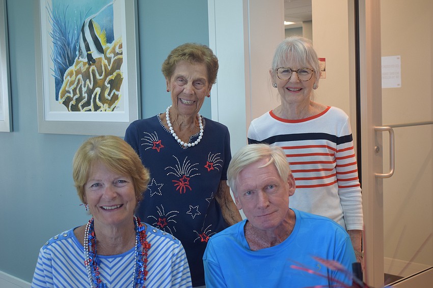 Nancy Hjort, Glen Hjort, Dottie Pirolli, and Marilyn Watsey helped decorate the clubhouse for the Seaplace Fourth of July party.