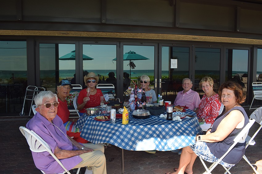 Mel Gang, Nancy Chanos, Sandy Endres, June Hessel, Dick Antonello, Sue Antonello, and Debbie Andy enjoying their Fourth of July dinner outside the Seaplace clubhouse.