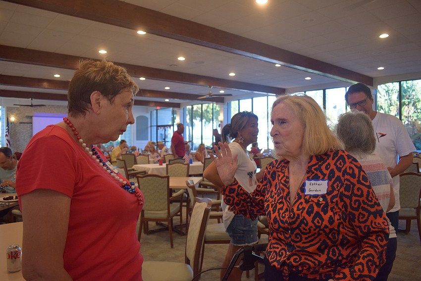 Karen Pashkow and Esther Gordon engaged in conversation at the Longboat Harbour Fourth of July party.