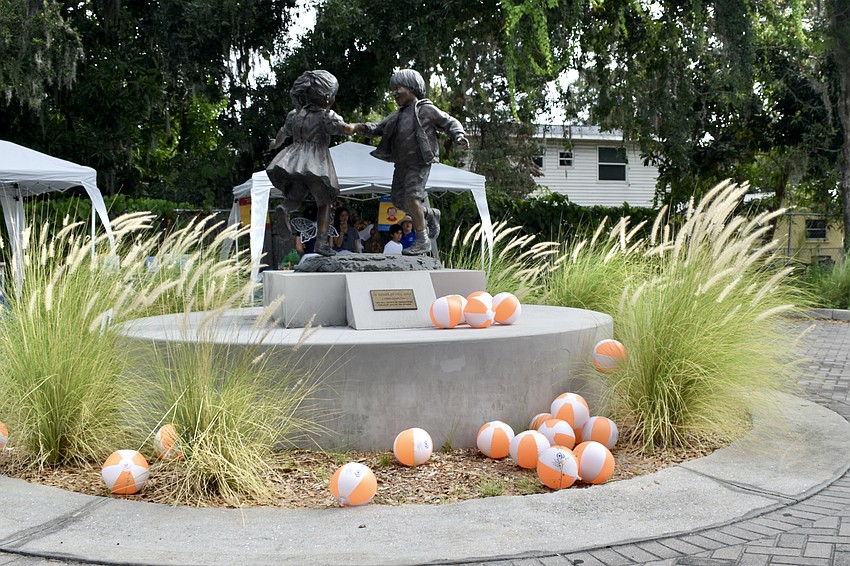 Inflatable balls adorn the statue in the event space.