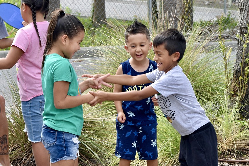 6-year-old Alizaiah Lopez, 3-year-old Johan Serna, and 7-year-old Aiden Bermudez play together.