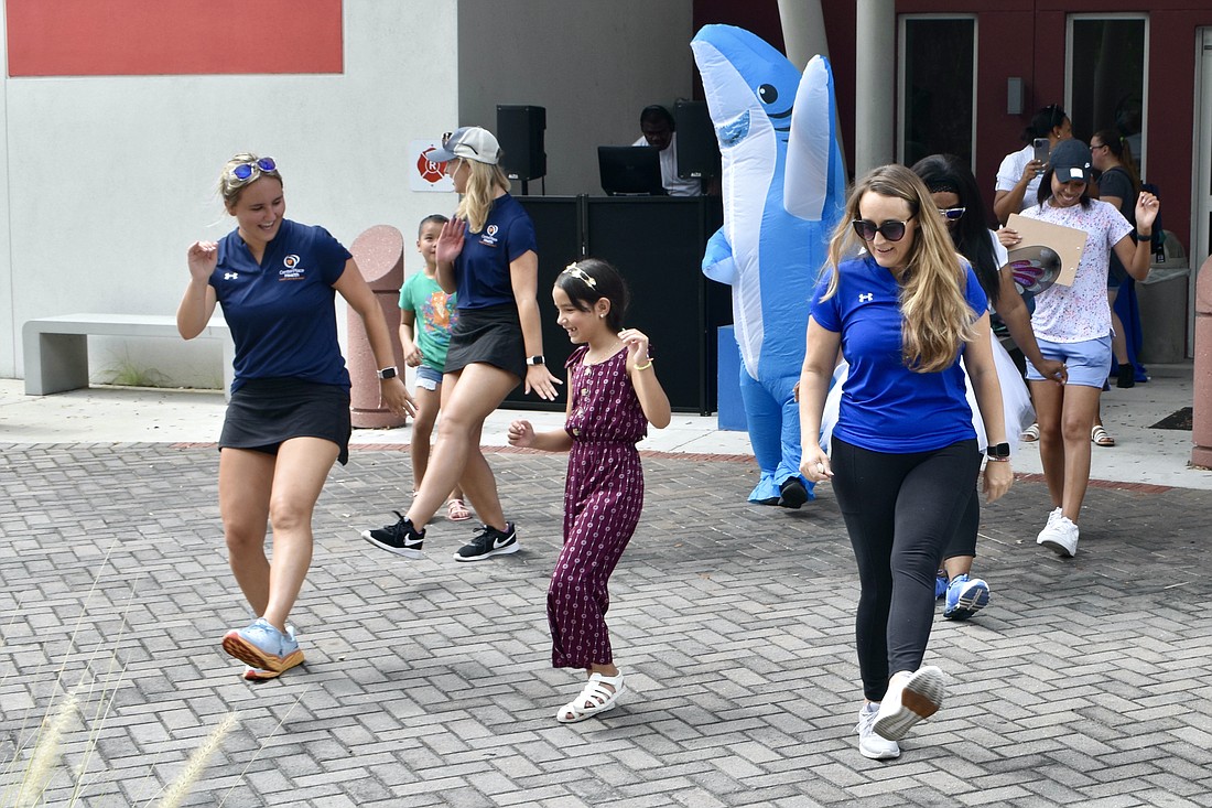 Grace Barger, 7-year-old Allison Silveira, and Shannon Carrasco get their groove on.