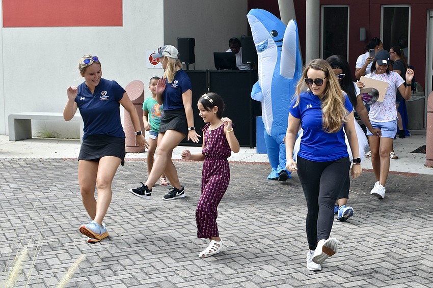 Grace Barger, 7-year-old Allison Silveira, and Shannon Carrasco get their groove on.