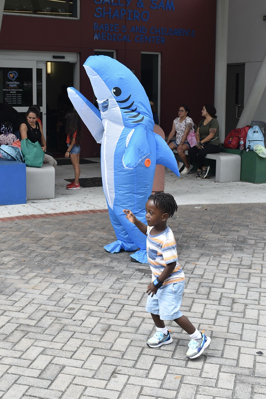 Abi Valez and 3-year-old Jamauri Williams dance in sync with one another.