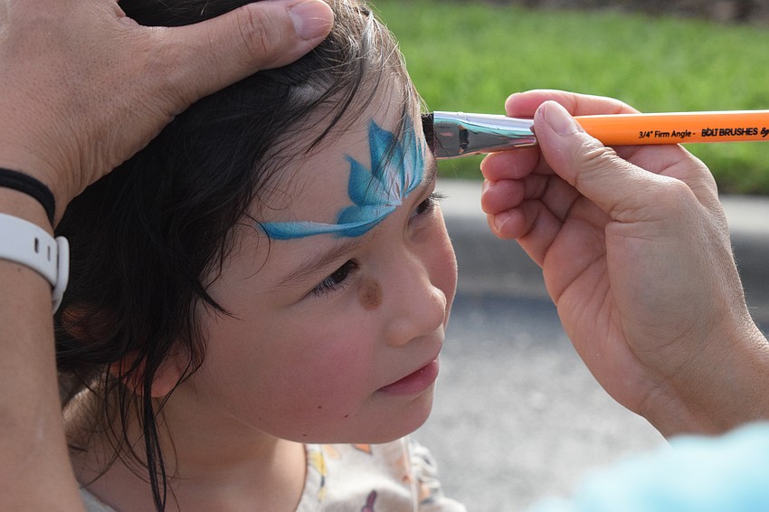 Lakewood Ranch's Juliette Hernandez, who is 4, stays as still as possible while she has her face painted.