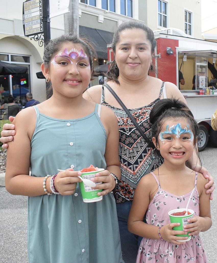 East County's Ariana Rojas, who is 11, Daniela Rojas and Aileen Rojas, who is 5, enjoy Kona Ice to get relief from the heat. 