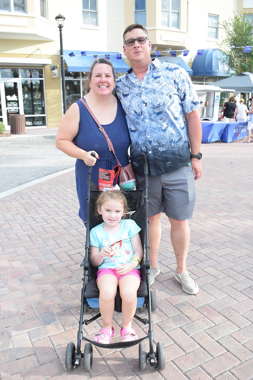Palmetto's Brandy Dingley, Ed Dingley and their 4-year-old daughter, Eliana Dingley, go to Music on Main for the bounce houses and good music.