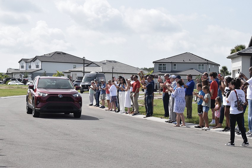 People line the street to welcome the Gaytan family to their new home in Sapphire Point of Lakewood Ranch.