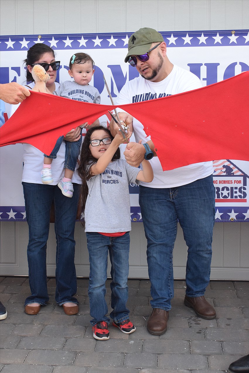 Ivette Gaytan celebrates being able to move into her family's new home in Sapphire Point of Lakewood Ranch with her 1-year-old daughter Lyanna, 6-year-old son Lucious and husband, Lucio Gaytan.