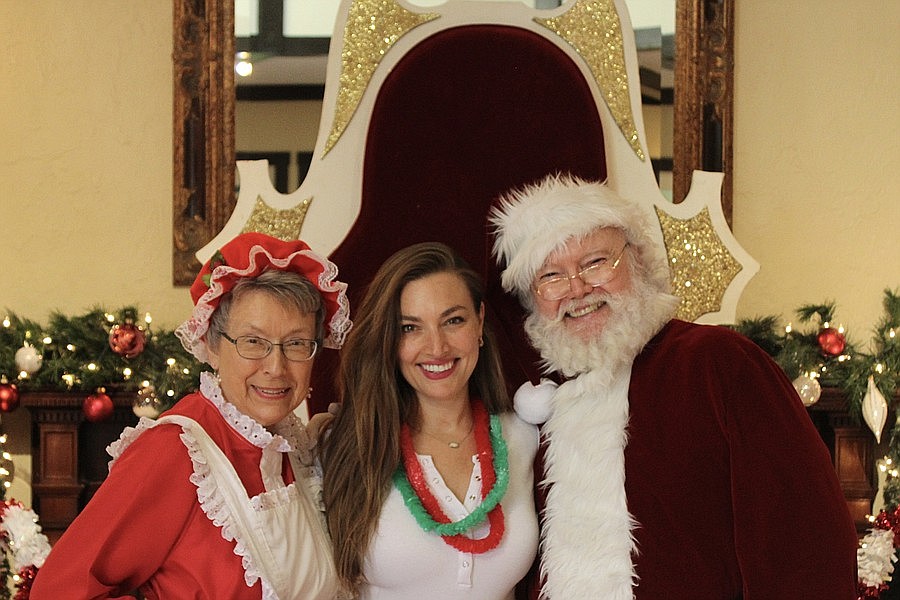 Ormond MainStreet Executive Director Becky Parker poses with Mrs. Claus and Santa Claus during the 2022 Christmas in July event. File photo by Alexis Miller