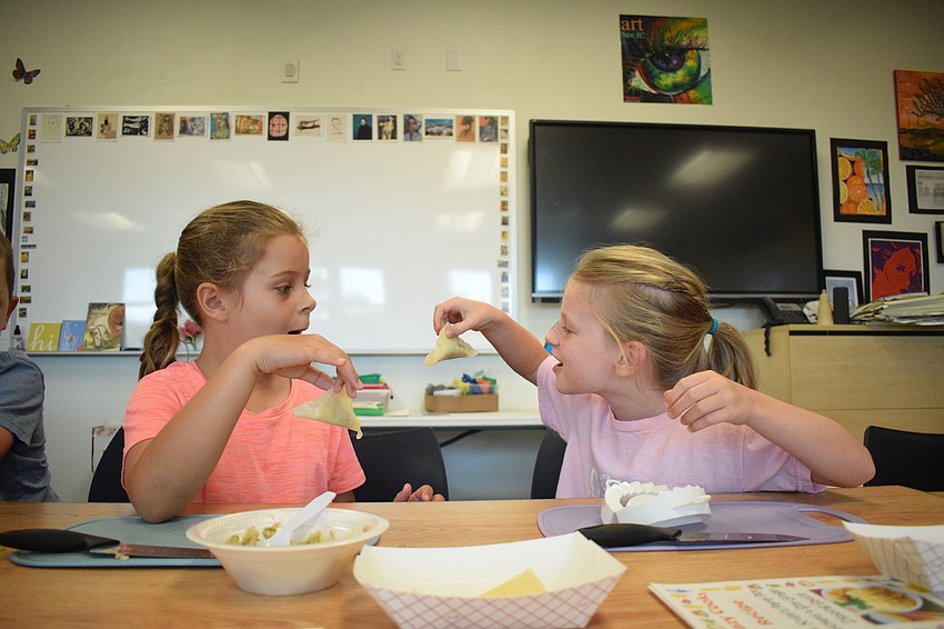 Rising second graders Norah Jawitz and Summer Allen are amazed at how well their potstickers came out. 