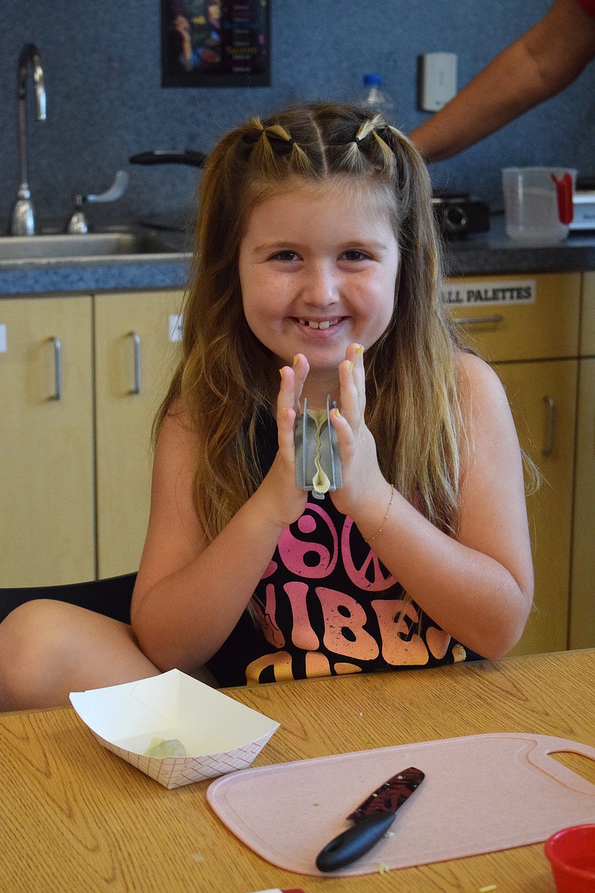 Stassi Bizzaro, a rising third grader, says she loves how she gets to learn how to cook cool recipes and bring them home to enjoy with her family.
