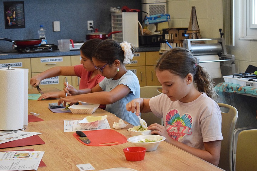 Payton Campbell, Brooke Oliver and Kaitlyn Olivo, who are all rising fifth graders, work diligently to make their potstickers.