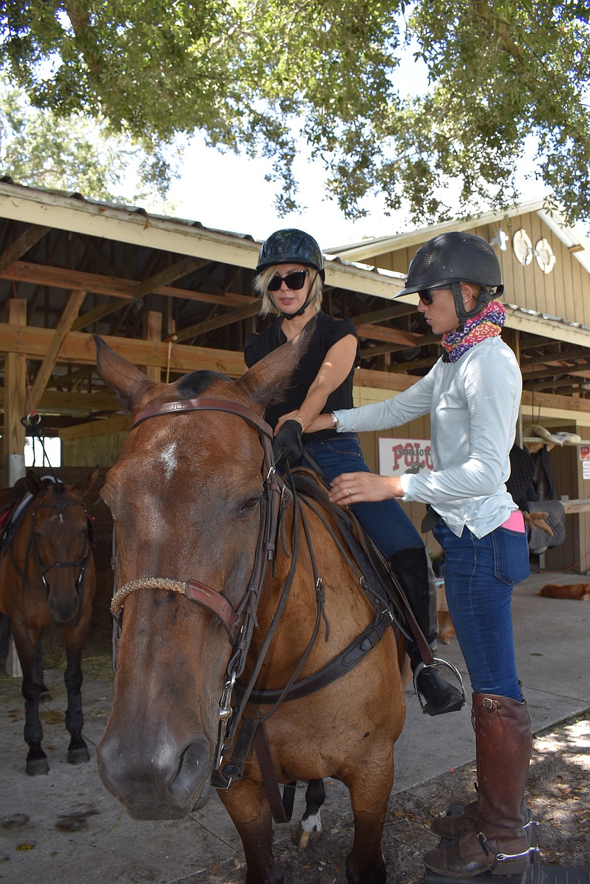 Karen Medford gets a few tips from instructor Ashlie Osburg before they head out to the practice field.