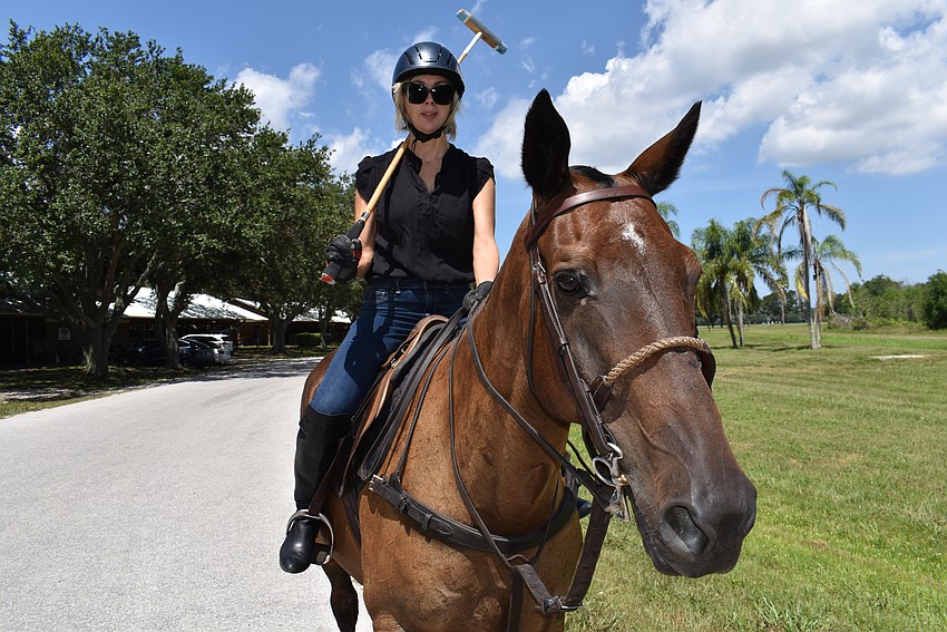 Karen Medford rides Pepe to the practice field at the Sarasota Polo Club.
