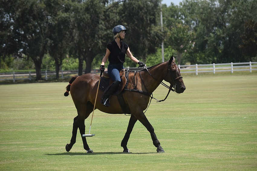 Karen Medford and Pepe work as a team during the lesson at the Sarasota Polo Club.