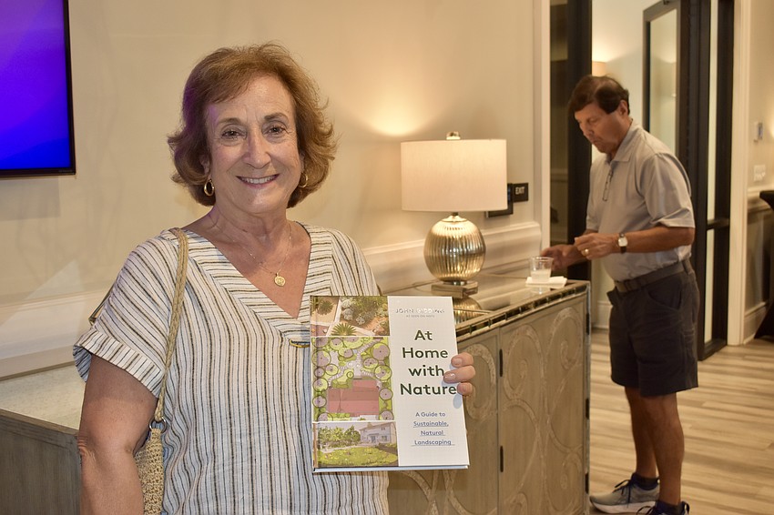 Country Club resident Francesca Tulski picks up a copy of Gidding's new book. She used to watch 