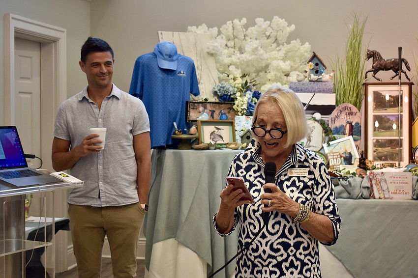 Carolyn Lowry, event organizer and charter member of Gardeners Out East, introduces book author and former HGTV host John Gidding.