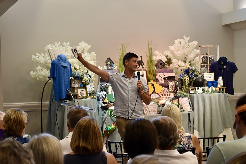 John Gidding holds up the free seeds he has for audience members who buy a book for a friend.