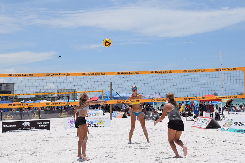A women's team practicing on an empty court before their game at the July Independence Volleyball Tournament on Lido Key Beach.